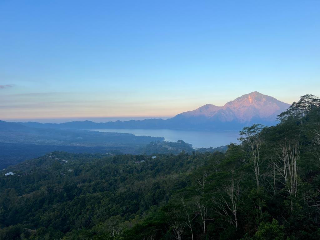 mount agung behind lake batur in the evening at sunset