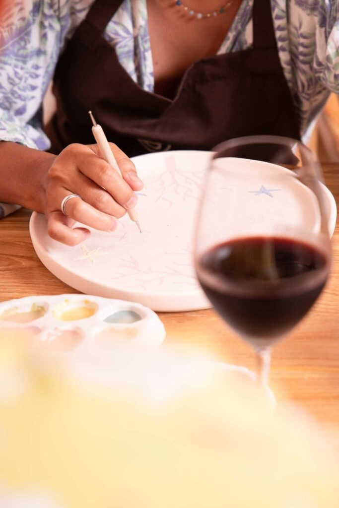 ceramic painting at klay bar bali with wine paint and sip