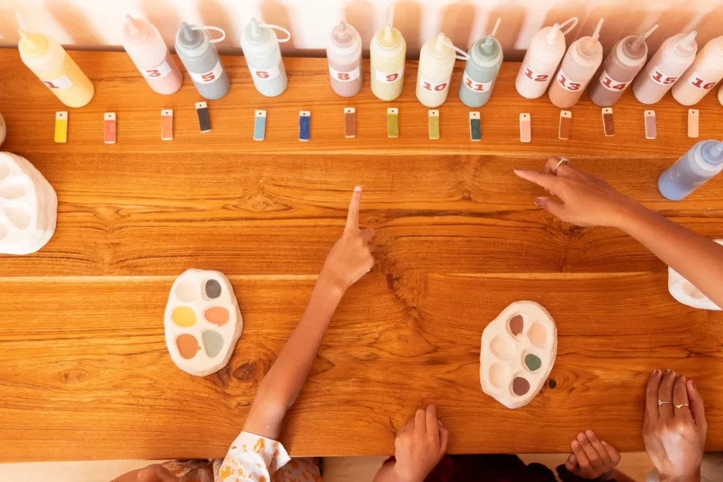 Choosing glaze colours is part of the fun, a hands-on moment where creativity begins to take shape, one shade at a time.